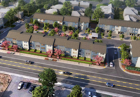 an aerial view of a row of houses with trees in front of them