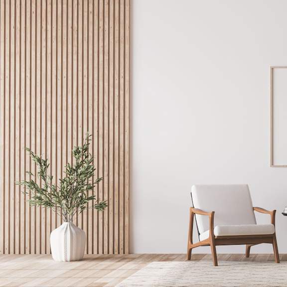 Two chairs with an end table, a potted plant, and a lamp.