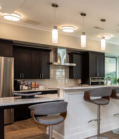 a kitchen with a large island with bar stools