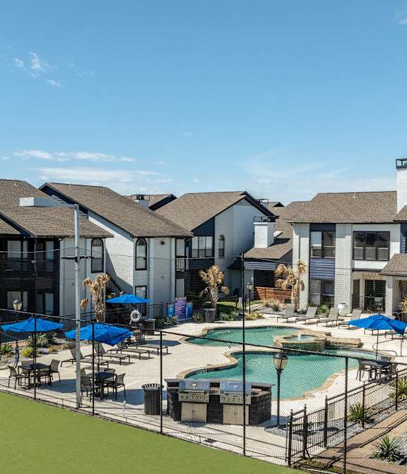 a view of a swimming pool with apartments in the background