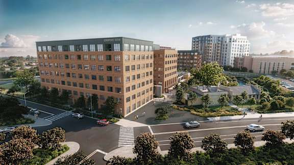 A large building with a parking lot in front of it.