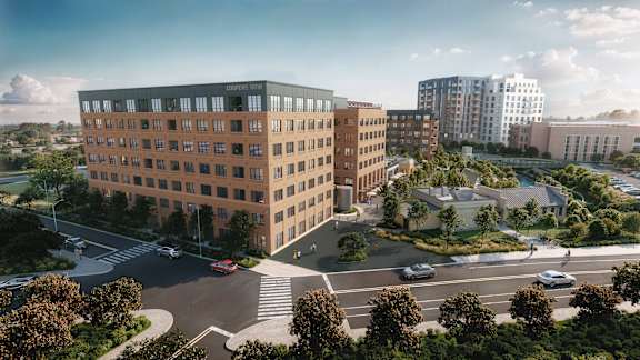 A large building with a parking lot in front of it.