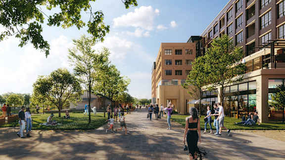 A group of people are walking and sitting in a park.