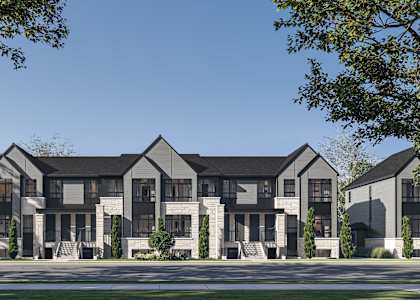 A row of modern houses with dark grey exteriors and white trim.