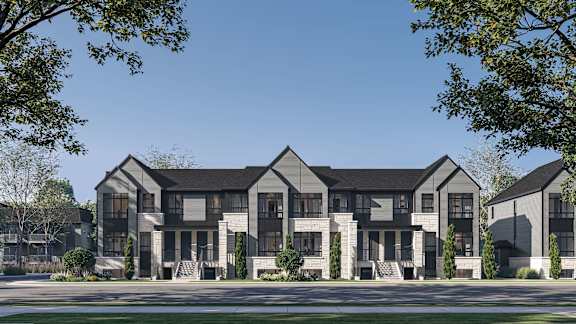 A row of modern houses with dark grey exteriors and white trim.