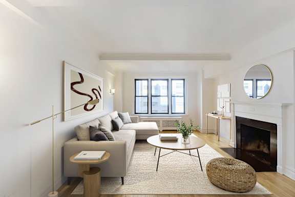 A living room with a fireplace and a large painting on the wall.at Sutton Collection, New York, 10022