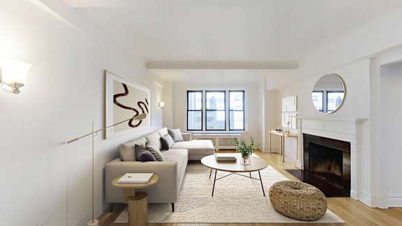 A living room with a fireplace and a large painting on the wall.at Sutton Collection, New York, 10022