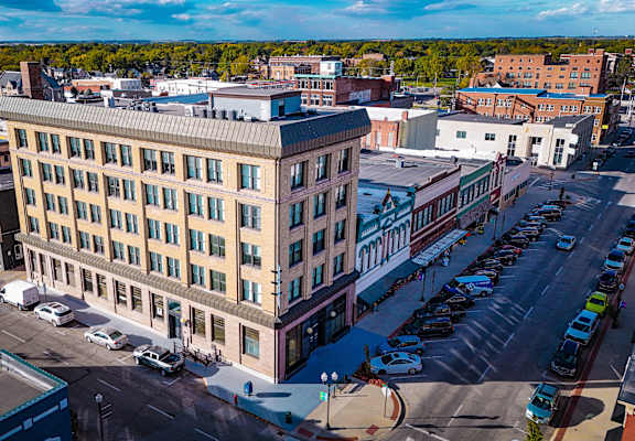 A large building with a parking lot in front of it.