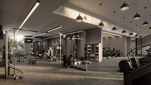 A gym with a variety of equipment including weights, machines, and a bench press.