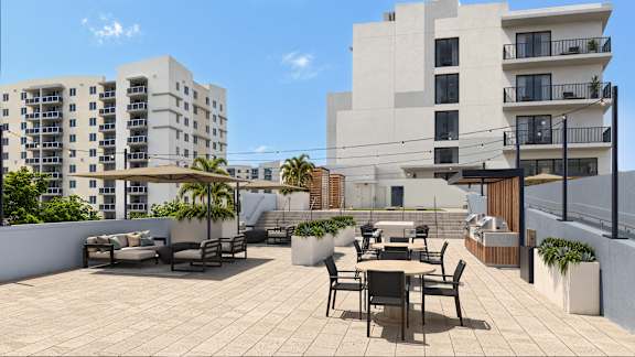 A sunny day at a rooftop patio with tables and chairs.