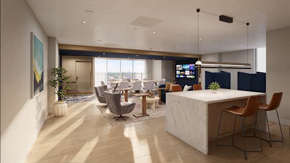 A modern office space with a reception desk and seating area.