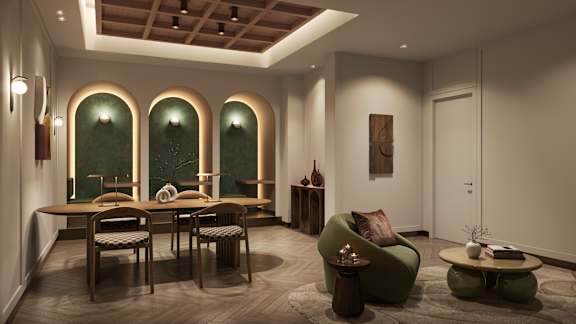 A room with a green sofa and a painting on the wall.