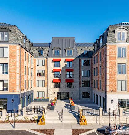 a view of a building with cars in a parking lot