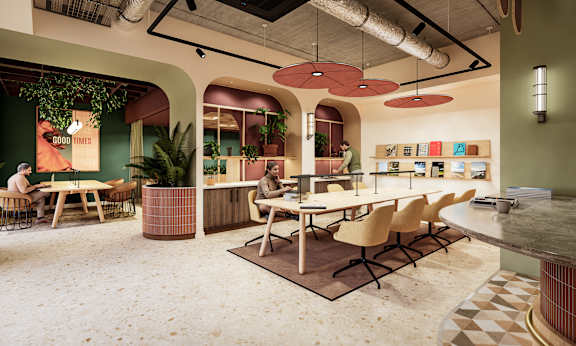 A modern office space with a green wall and a sign that says "Good Times".