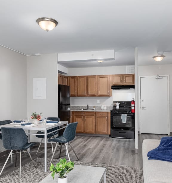 a living room with a table and chairs and a kitchen