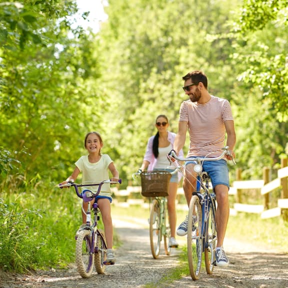 a family riding bikes down a dirt road at Woodcreek, Poulsbo, 98370