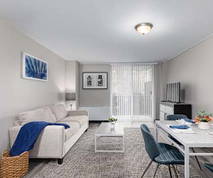 a living room with a white couch and a table and chairs