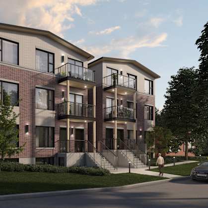 A modern apartment building with a car parked in front.