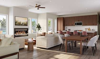 A modern living room with a fireplace and a dining area.