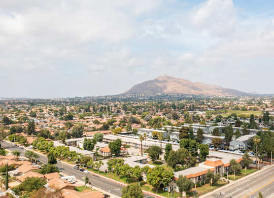A cityscape with a large mountain in the background.