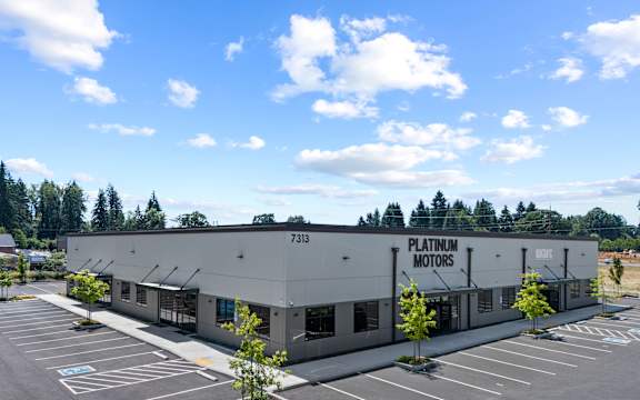 A building with the sign Platinum Motors on the front.
