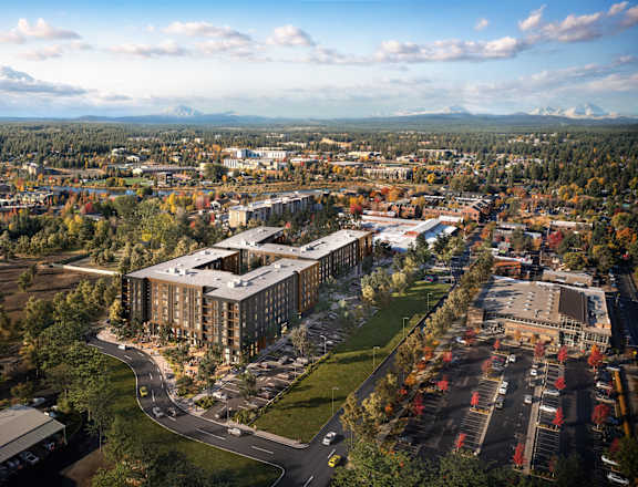 A large building complex is under construction in the middle of a city.