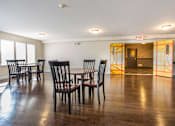 Thumbnail 8 of 11 - Community Room with tables and chairs and refrigerator