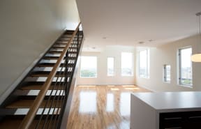 Living room, kitchen and staircase to upper floor of loft