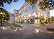Thumbnail 13 of 13 - A large building with a courtyard in front of it.