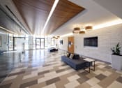 Thumbnail 9 of 13 - A modern lobby with a checkered floor and a wooden ceiling.