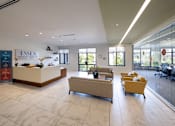 Thumbnail 6 of 13 - A reception area with a desk and chairs is shown.