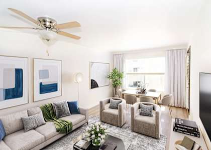 a living room with a couch and chairs and a table