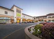 Thumbnail 2 of 13 - A Whole Foods store is shown with a parking lot in front.