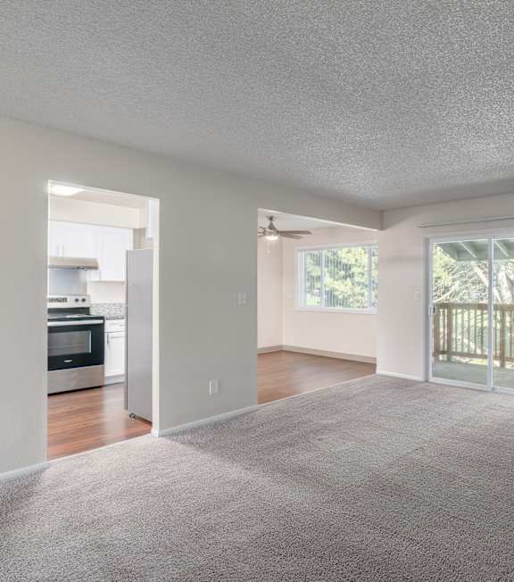 an empty kitchen with wooden cabinets and stainless steel appliances