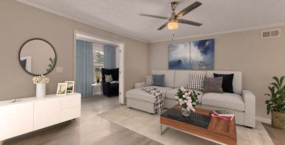 A modern living room with a white sofa, a coffee table, and a ceiling fan.