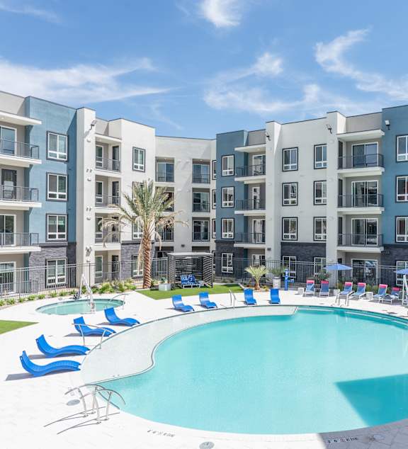 group of young people in a swimming pool at Fora Apartments in Las Vegas, NV