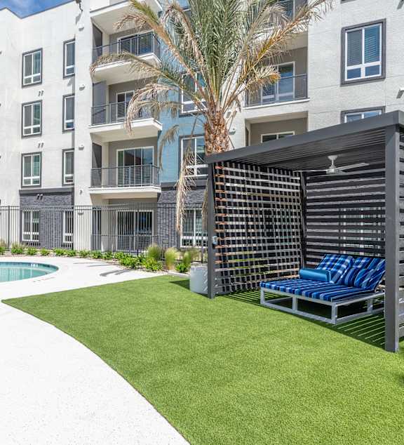 a rendering of an apartment building with cars parked in front of it at Fora Apartments in Las Vegas, NV