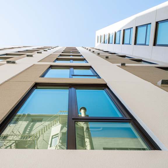 A tall building with a clear blue sky in the background.