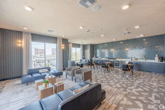 A spacious living room with a dining area and a balcony with a view of the city.