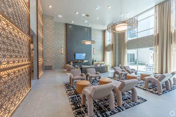 A modern living room with a patterned wall and a large window.