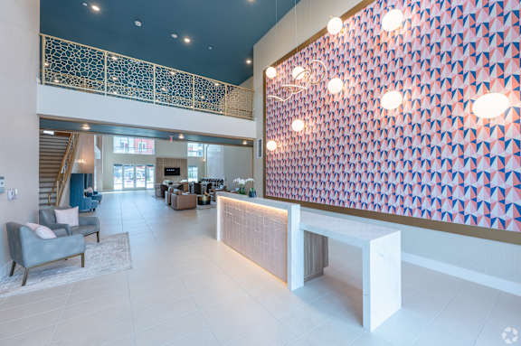 A large room with a staircase and a wall with lights.