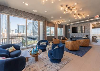 a living room with couches and chairs and a television at Aura Vegas Apartments, Nevada, 89103