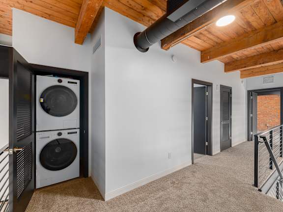 small laundry room with machines at Life At Agora Apartments, Cleveland, Ohio