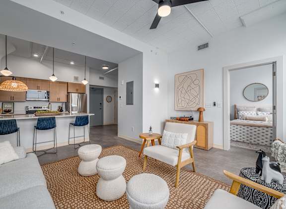 A living room with a kitchen area in the background at Life At Agora, Cleveland