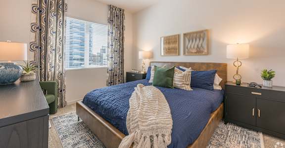 a bedroom with a large bed and a ceiling fan at Aura Vegas Apartments, Nevada, 89103