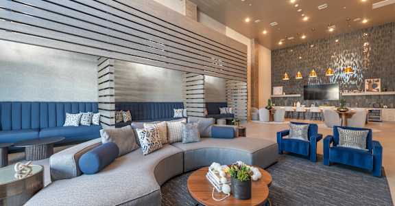 a lobby with couches and chairs and a table at Aura Vegas Apartments, Nevada, 89103