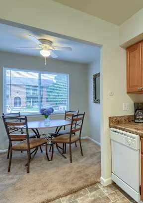 a kitchen with wooden cabinets and a white dishwasher