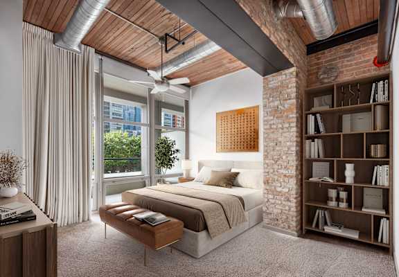 A bedroom with a bed, a bookshelf, and a window with curtains.