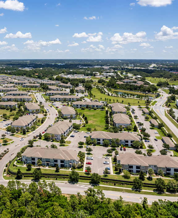 A bird's eye view of a residential area with houses and roads.
