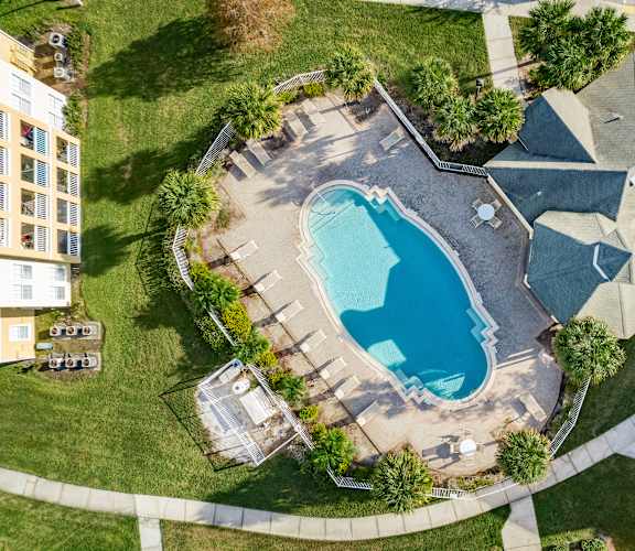 An aerial view of a house with a swimming pool.